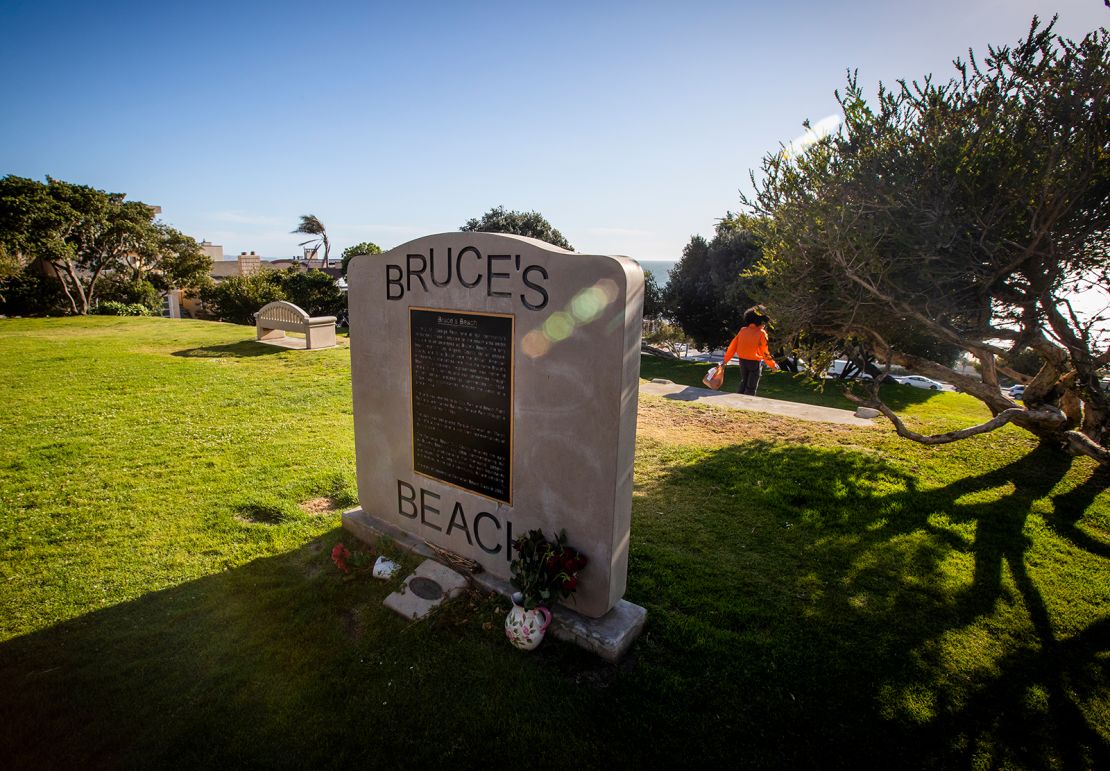 The Bruce's Beach plaque is at the top of a hill, with the lifeguard building below.