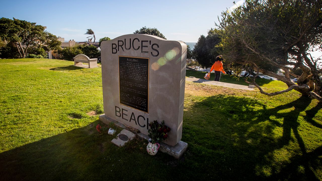 The Bruce's Beach plaque is at the top of a hill, with the lifeguard building below.