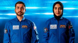 In this undated handout photograph from the United Arab Emirates' state-run WAM news agency, newly named Emirati astronauts Mohammed al-Mulla, left, and Noura al-Matroushi, right, pose for a photo. The United Arab Emirates named the next two astronauts in its space program Saturday, April 10, 2021, including the country's first female astronaut. (WAM via AP)