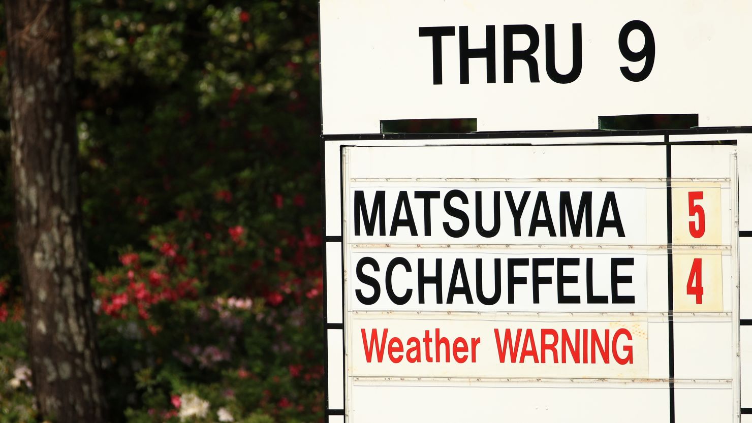 A detail of 'weather warning' signage on a leaderboard during the third round of the Masters.