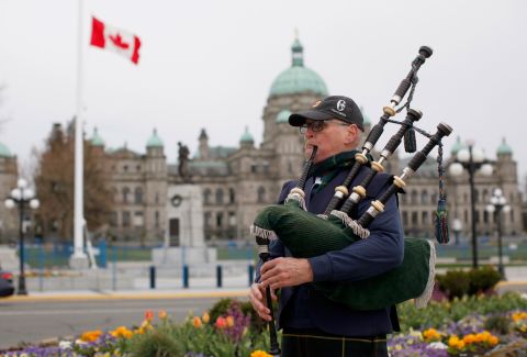 Piper Ken Wilson plays the "Heights of Dargai" in honor of Prince Philip while the Canadian flag flies at half-staff at the British Columbia Legislature.