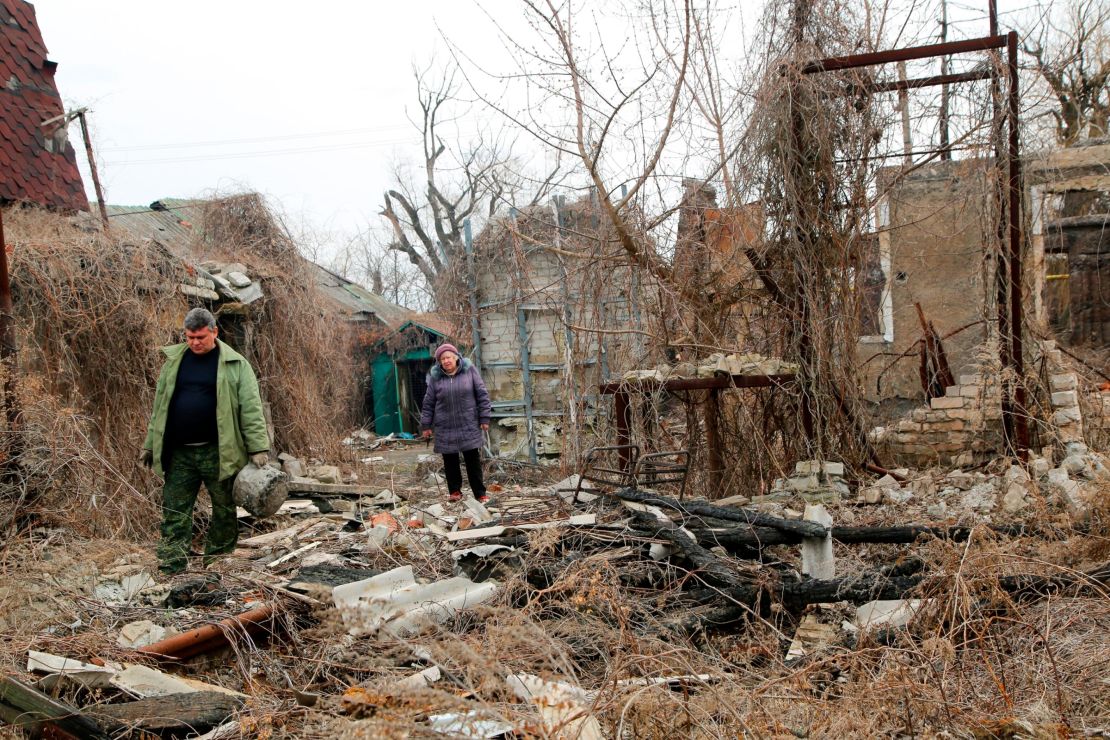 Residents return to look for belongings in their destroyed home near a front line in eastern Ukraine earlier this month.
