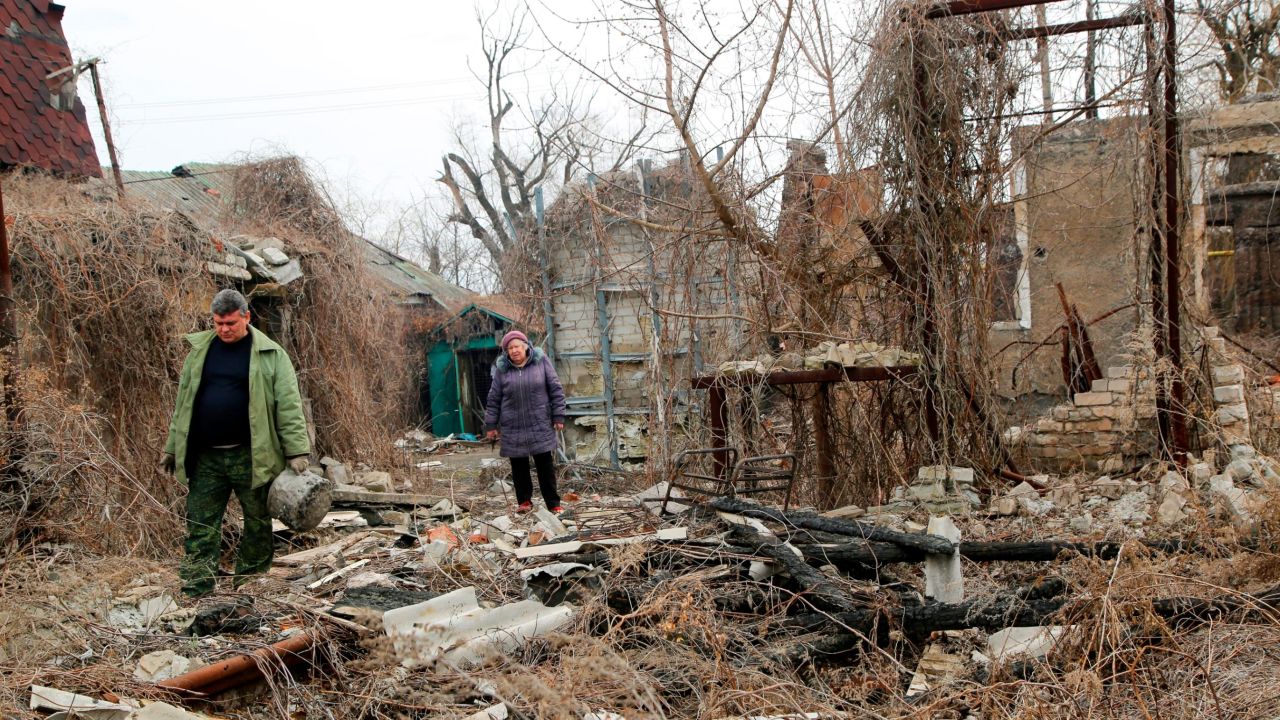 Residents return to look for belongings in their destroyed home near a front line in eastern Ukraine earlier this month.