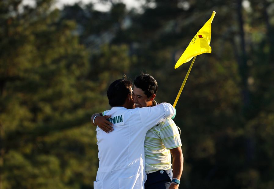 Matsuyama celebrates with his caddie, Shota Hayafuji, on the 18th green Sunday.