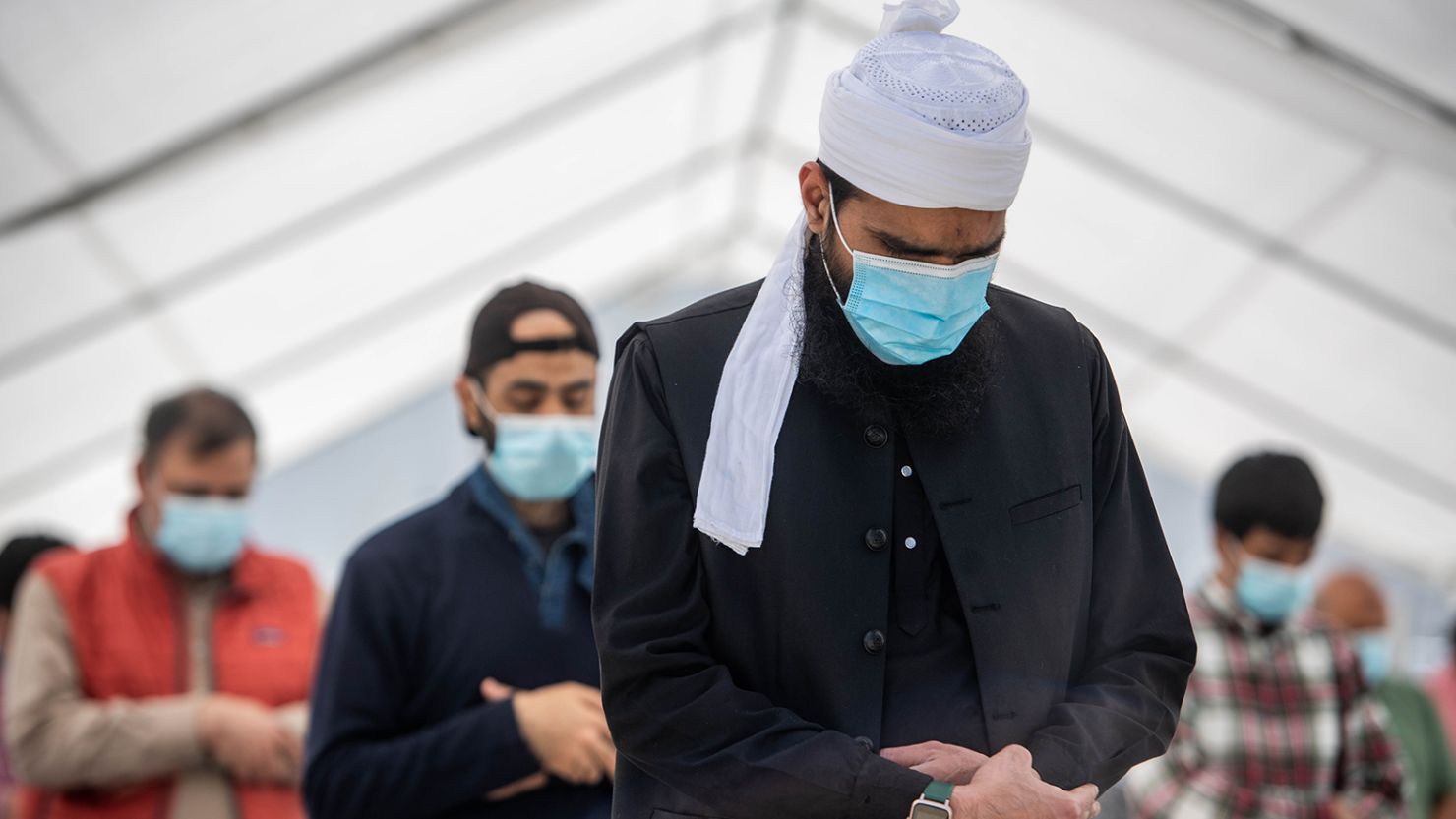 Men attend socially distanced Friday afternoon prayers in the parking lot of King Fahad Mosque in Culver City, California, on Friday, April 9, 2021.