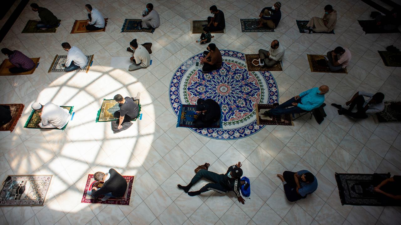 Men space out their prayer rugs during prayers at King Fahad Mosque in Culver City, California.
