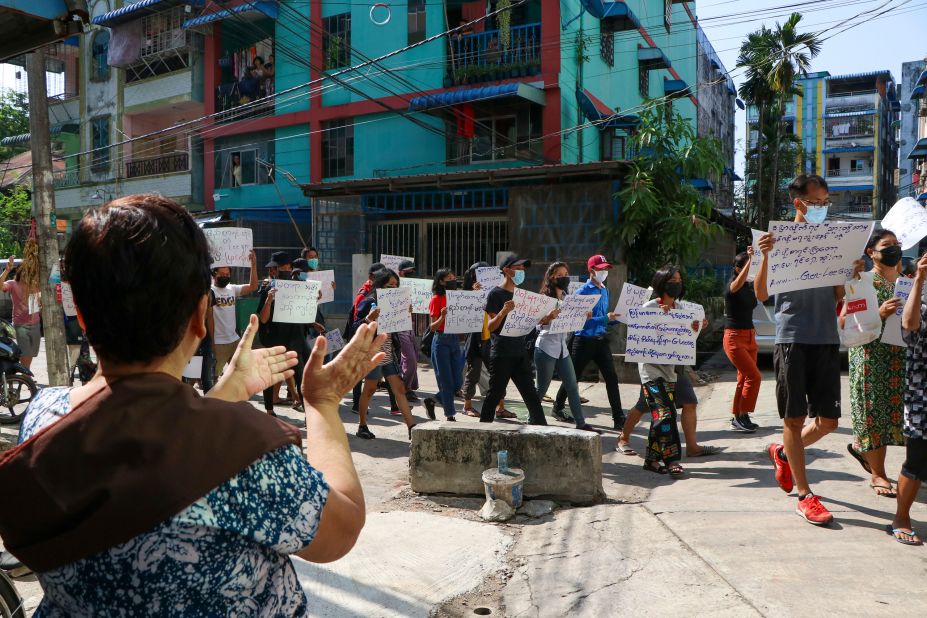 Anti-coup protesters walk through Yangon's Hlaing township on April 9.