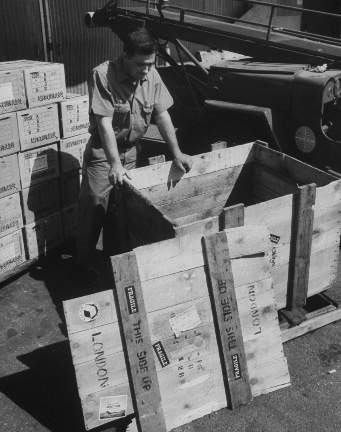 A Pan Am service representative examines the crate that Brian Robson was found in back in 1965.