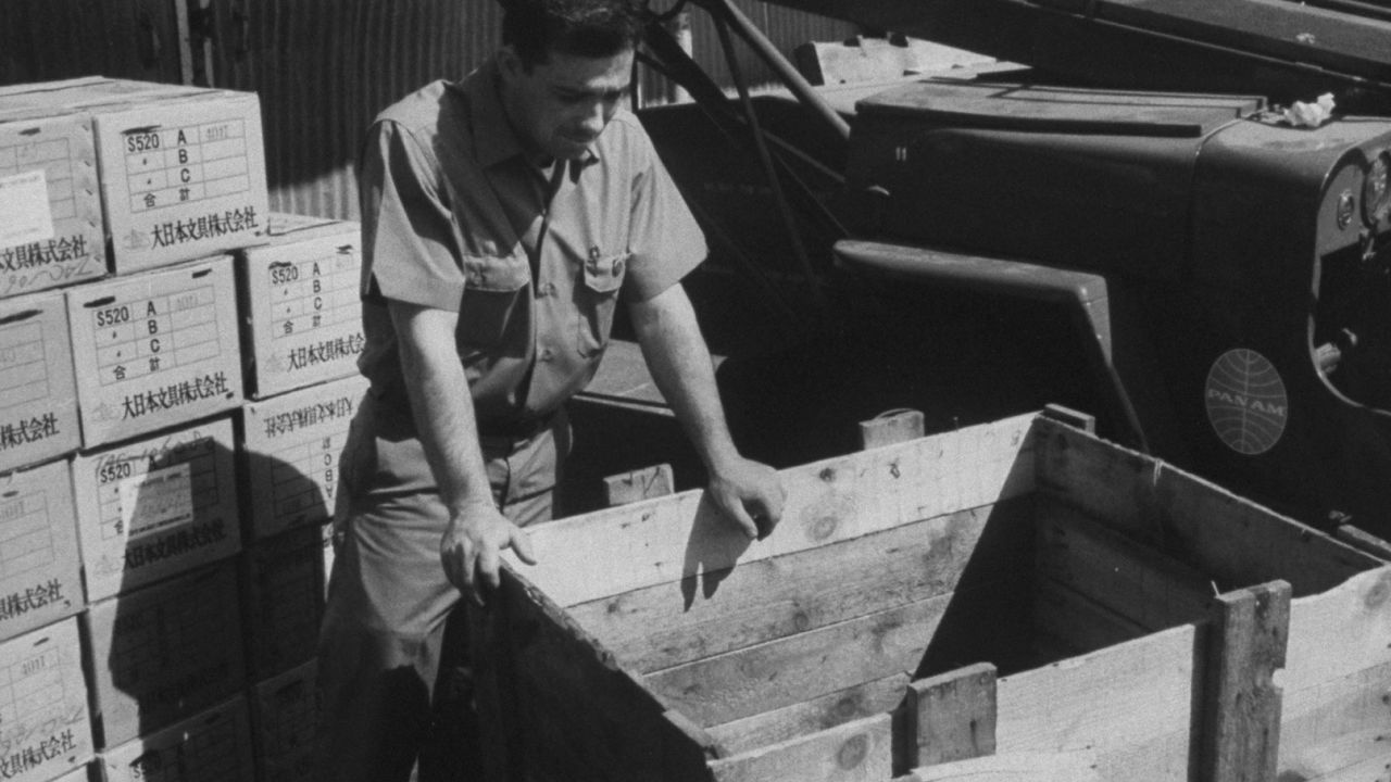 A Pan Am service representative examines the crate that Brian Robson was found in back in 1965.