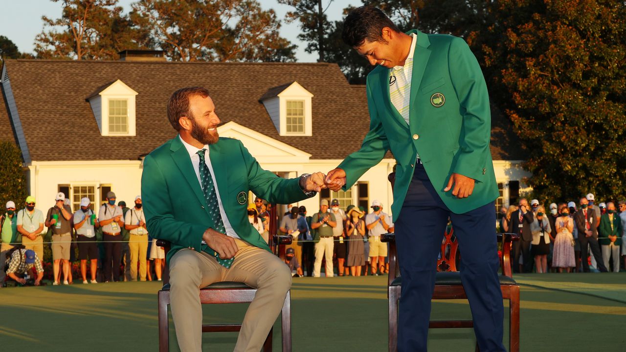 Matsuyama fist bumps 2020 champion Dustin Johnson during the Green Jacket ceremony after Matsuyama won the Masters.