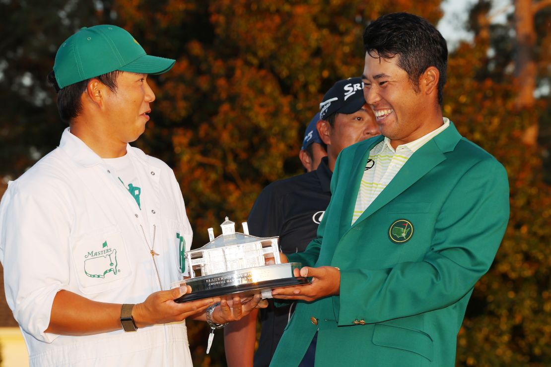 Matsuyama poses with his caddie, Hayafuji, and the Masters trophy.
