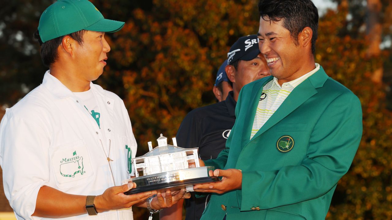 Matsuyama poses with his caddie, Hayafuji, and the Masters trophy.