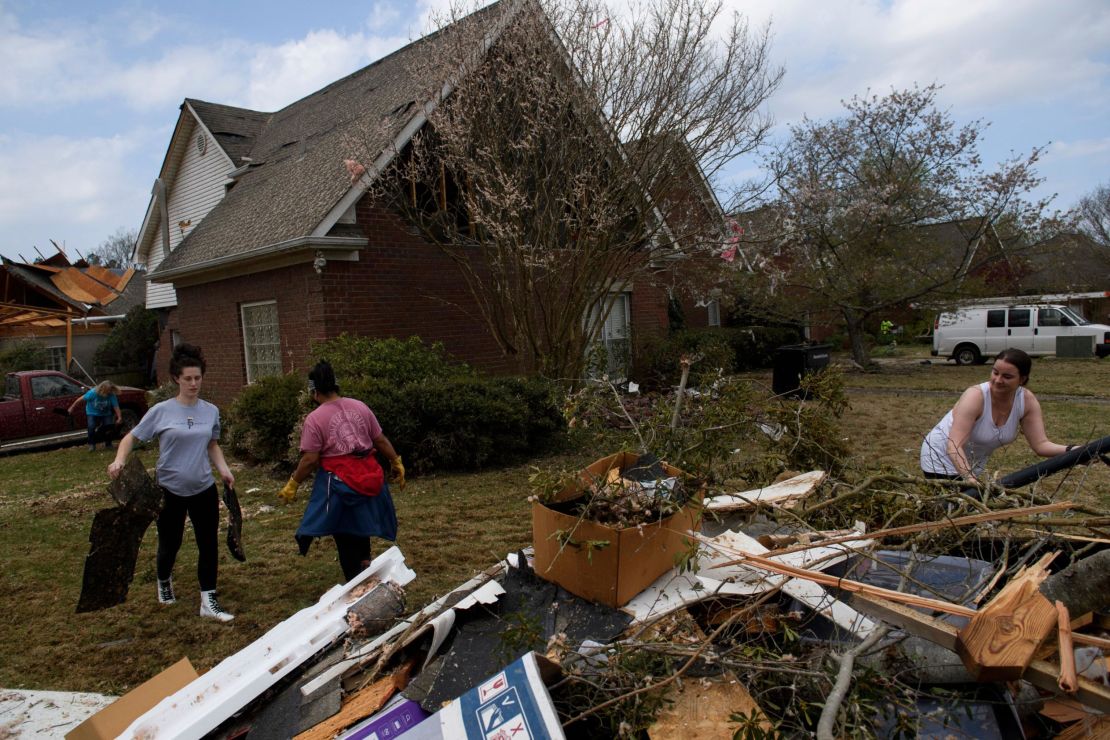 Volunteers clean up debris on March 26, following a tornado that hit the Eagle Point community south of Birmingham, Alabama. 