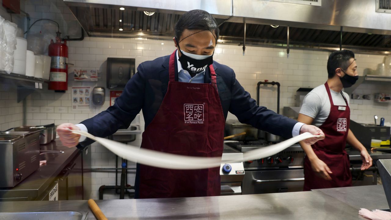 Yang hand pulls noodles as he visits Xi'an Famous Foods in Chinatown on March 5, 2021 in New York City. Yang went behind the counter with owner Jason Wang to hand pull noodles at the restaurant and to hear from workers and others about recent acts of discrimination against the Asian community.