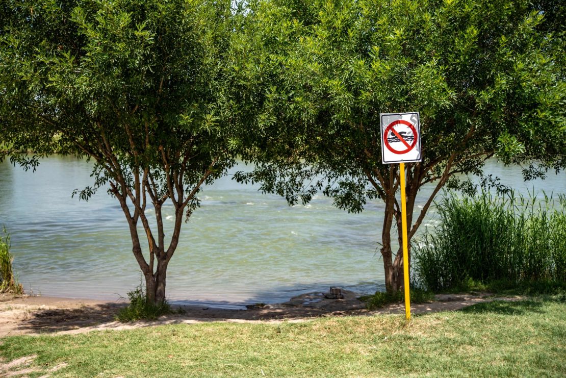 This file photo from 2019 shows a "No Swimming" sign near the Rio Grande in Piedras Negras, Mexico. The mother we met told us her family was on the banks of the river in Piedras Negras when they decided to separate.