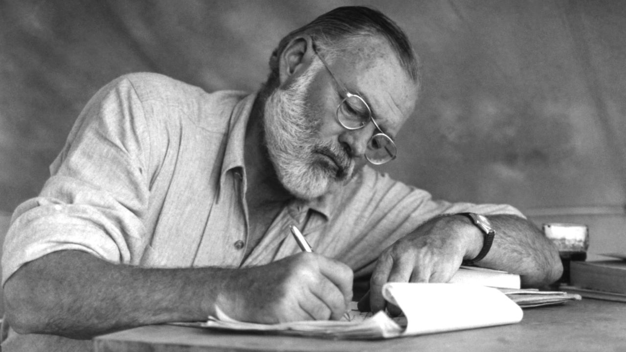 Ernest Hemingway working at a portable table while on a big game hunt in Kenya, September 1952.