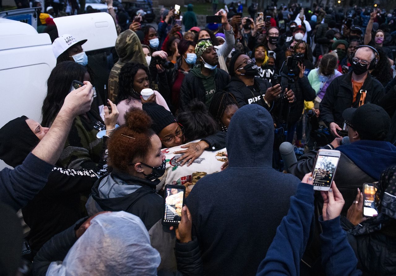 People embrace Wright's mother, Katie, as protesters gathered on Sunday.