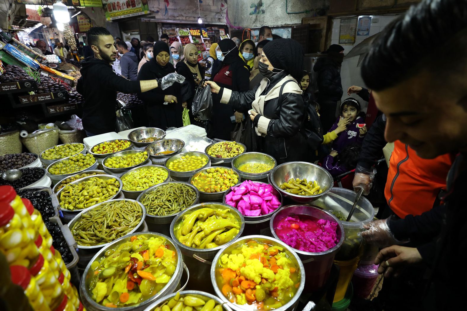 Ahead of Ramadan, a woman buys pickles at a market in Nablus, West Bank.