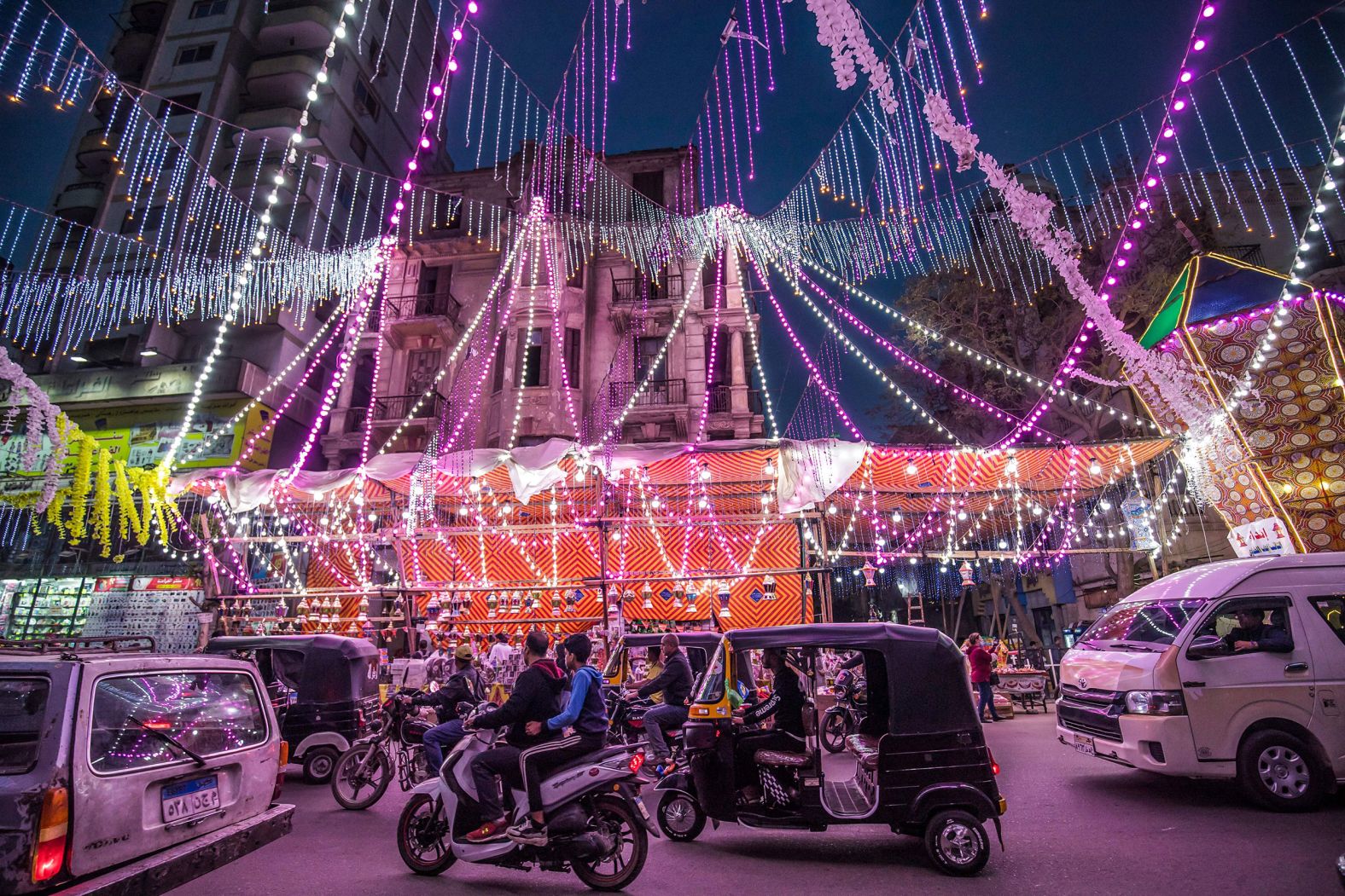 People drive past a stall selling Ramadan lanterns in Shubra, a suburb of Cairo.