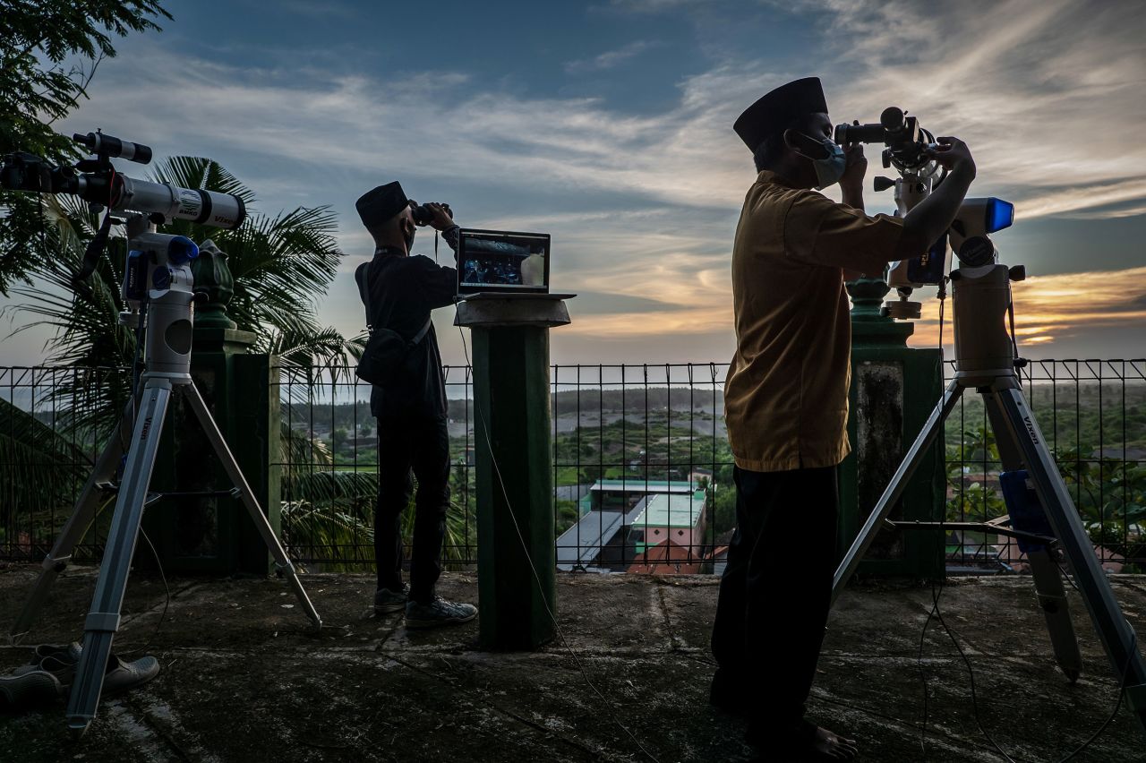 A man in Yogyakarta, Indonesia, prepares a telescope to observe the new moon that marks the start of Ramadan.