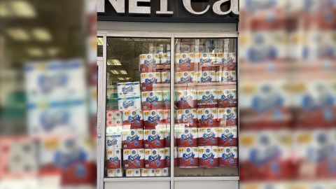 A convenience store window displaying lots of toilet paper in New York City on March 20, 2021.
