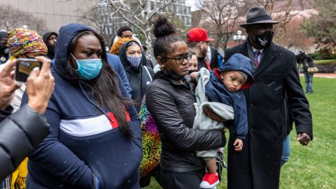 Floyd family lawyer Ben Crump (right) and Chyna Whitaker, Daunte Wright's girlfriend (center), holding their son, leave a news conference at the Hennepin County Government Center in Minneapolis on Tuesday.