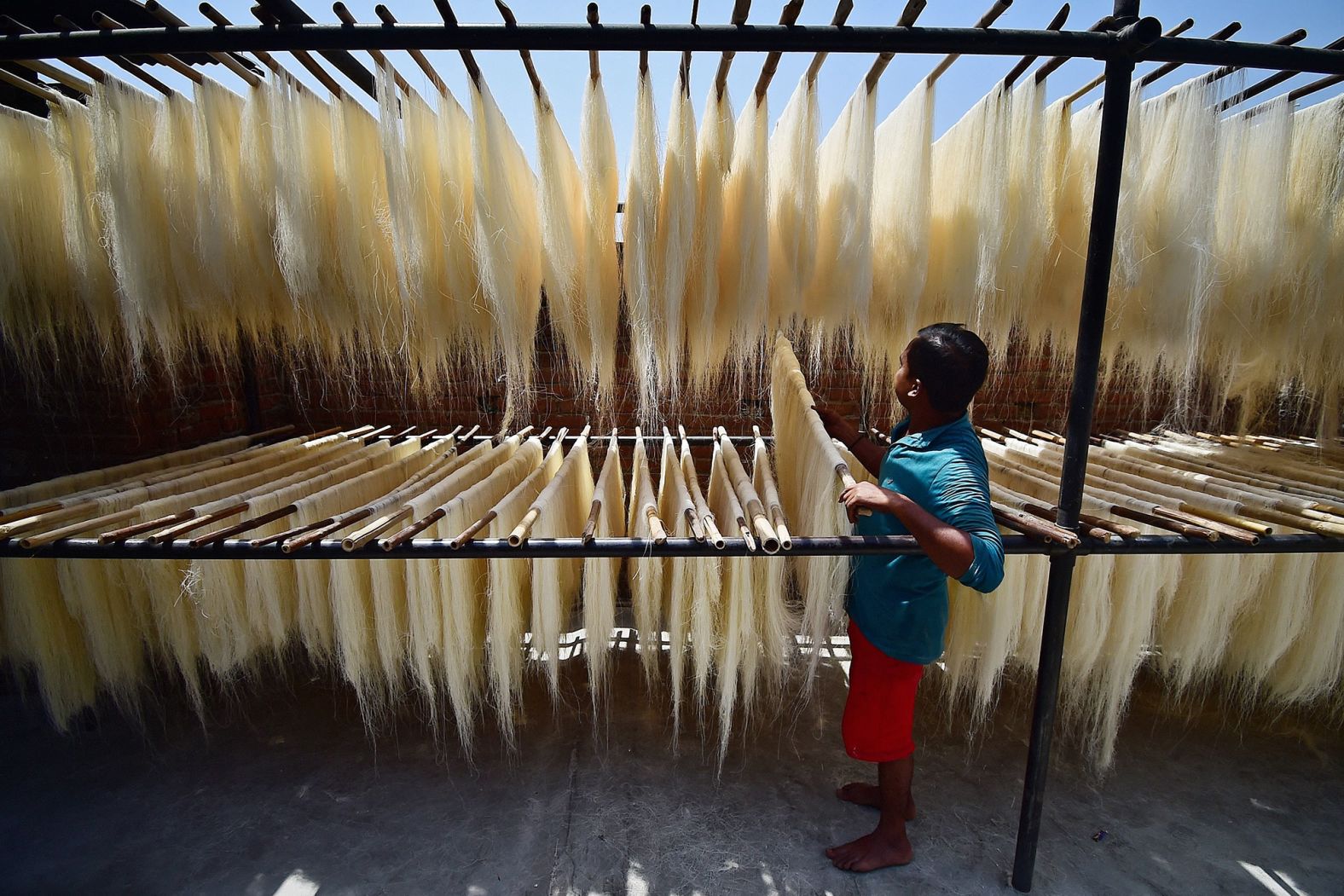 Workers in Allahabad, India, prepare vermicelli, which is used in a traditional sweet dish popularly consumed during Ramadan.