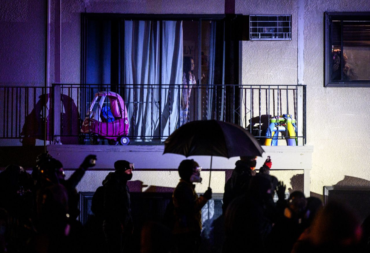 People confront law enforcement Tuesday outside an apartment complex near the Brooklyn Center Police Department.