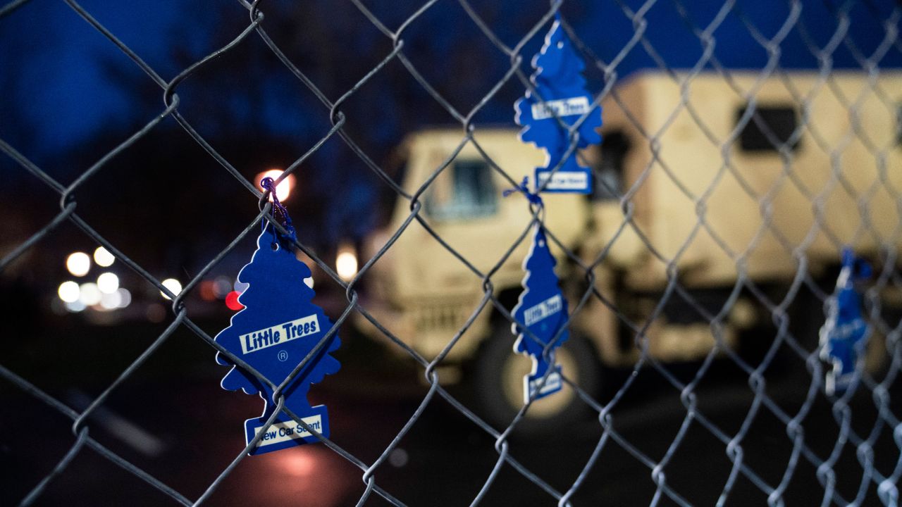 Demonstrators hang car air fresheners from a perimeter fence outside the Brooklyn Center Police Department to protest the shooting death of Daunte Wright, late Tuesday, April 13, 2021, in Brooklyn Center, Minn. (AP Photo/John Minchillo)