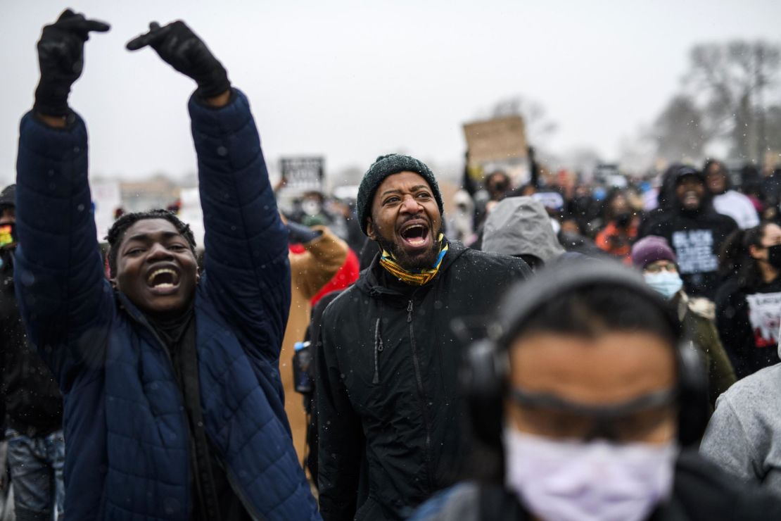 Minnesota State Rep. John Thompson, center, marches with protesters outside the Brooklyn Center police headquarters on Tuesday in Brooklyn Center, Minnesota. 