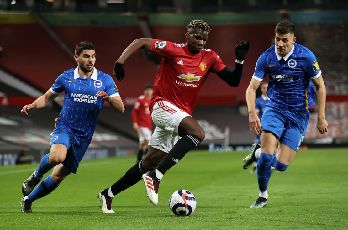 United midfielder Paul Pogba battles for possession with Jakub Moder (right) and Neal Maupay (left) of Brighton & Hove Albion.