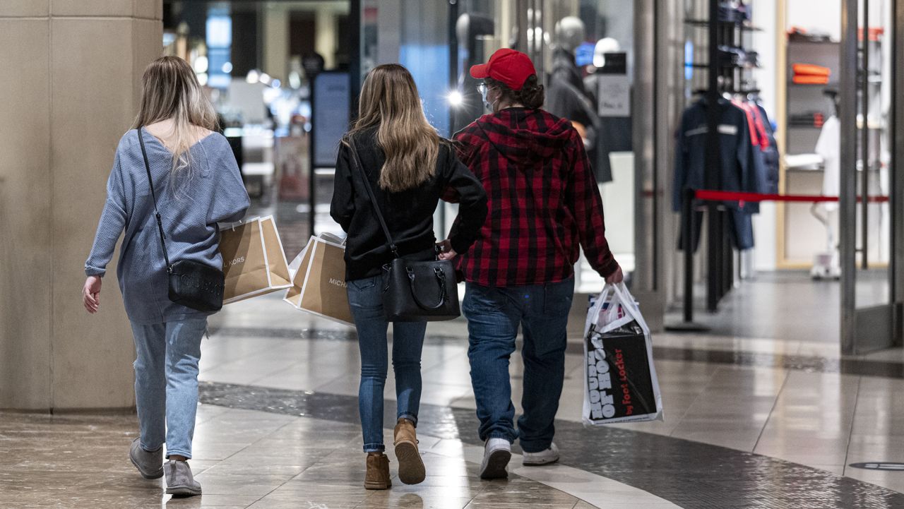 Shoppers wearing protective masks carry bags inside the Westfield San Francisco Centre shopping mall in San Francisco, California, U.S., on Tuesday, March 9, 2021. San Francisco Mayor London Breed said indoor dining, movie theaters and gyms can reopen on a limited basis after California moved the region to a less-restrictive tier. Photographer: David Paul Morris/Bloomberg via Getty Images