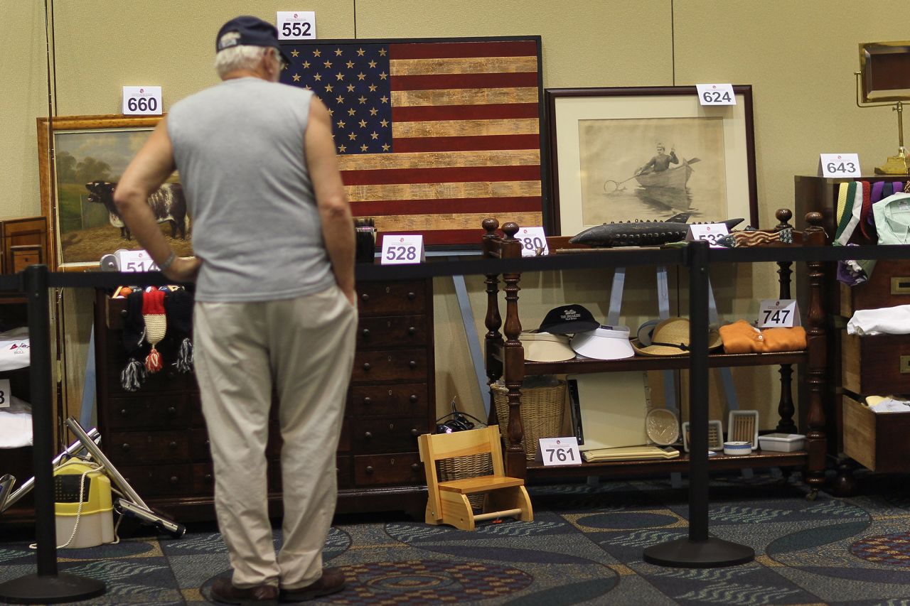 A person looks at some of the items from Madoff's estate that were auctioned off in Miami Beach, Florida, in June 2011.