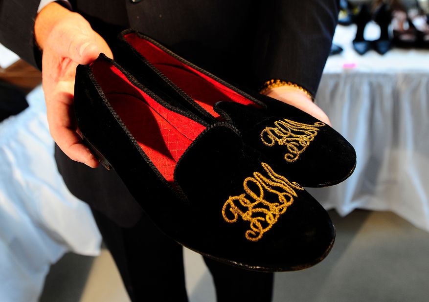 A pair of slippers that belonged to Madoff, with his embroidered initials, are displayed before an auction in November 2010.