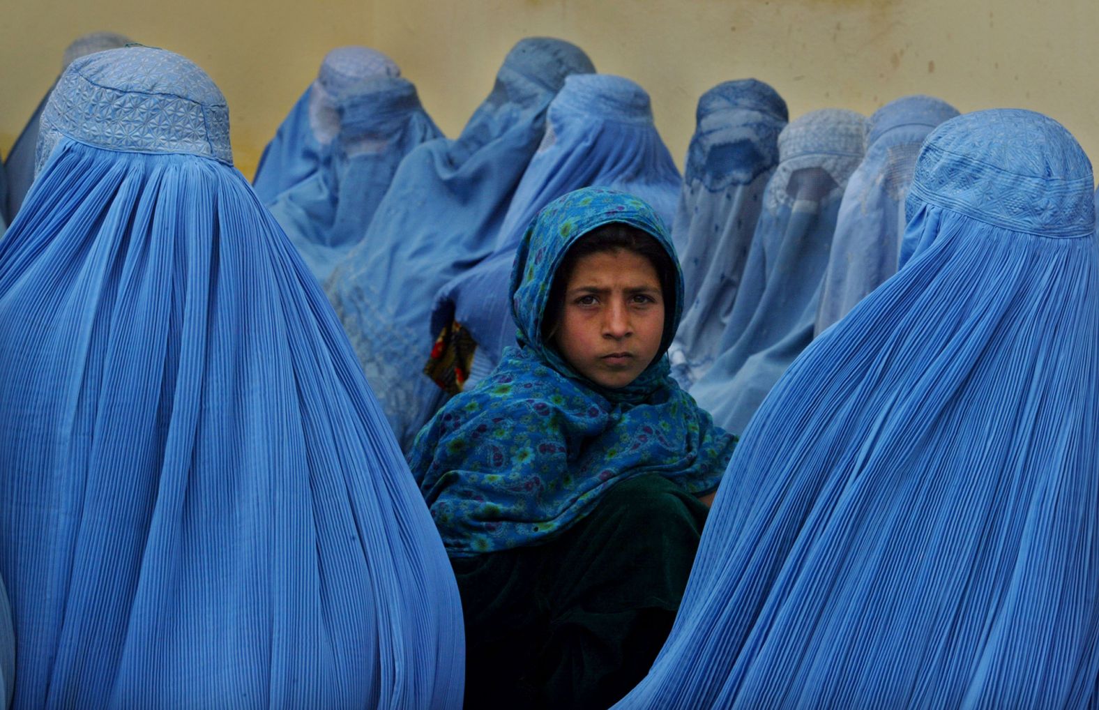 Women wait in line to be treated at a health clinic in Kalakan, Afghanistan, in February 2003.