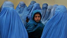 KALAKAN,  AFGHANISTAN - FEBRUARY 23:  Afghan women wait in line to be treated at the Kalakan health clinic February 23,2003 in Kalakan, Afghanistan.  (Photo by Paula Bronstein/Getty Images)