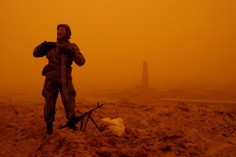 An Afghan soldier provides security at the site where a US helicopter crashed near Ghazni, Afghanistan, in April 2005. At least 16 people were killed.