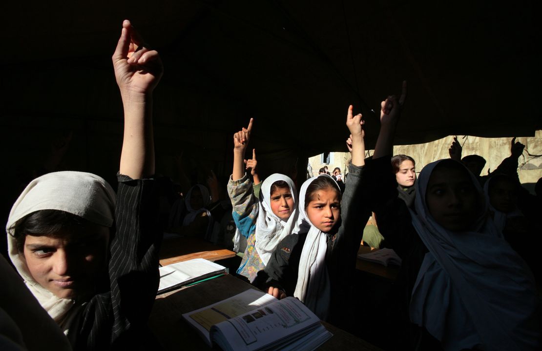 Afghan girls raise their hands during English class in Kabul, Afghanistan in 2006. The Taliban have announced new restrictions on girls' education.