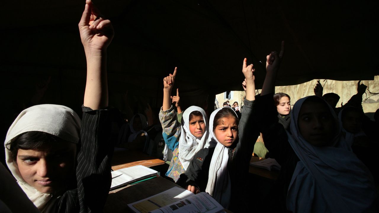 Afghan girls raise their hands during English class in Kabul, Afghanistan in 2006. The Taliban have announced new restrictions on girls' education.