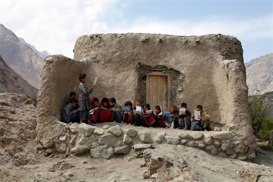 Afghan students recite Islamic prayers at an outdoor classroom in the remote Wakhan Corridor in September 2007.