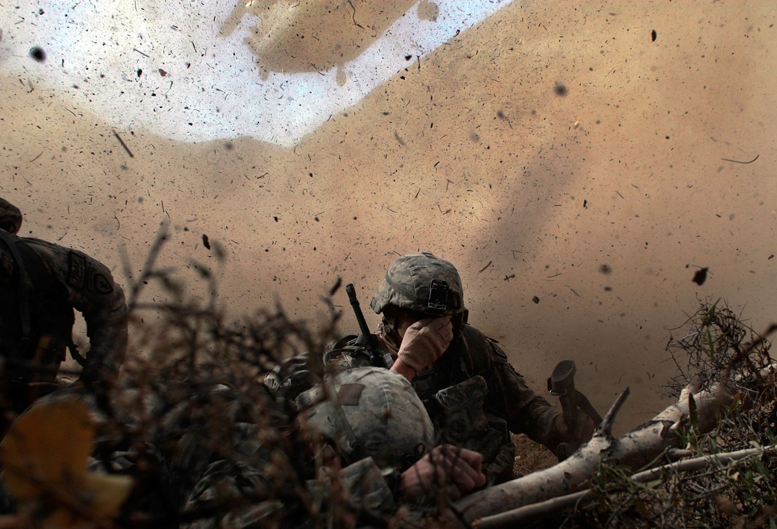 US soldiers shield their eyes from the rotor wash of a Chinook helicopter as they are picked up from a mission in Afghanistan's Paktika province in October 2009.