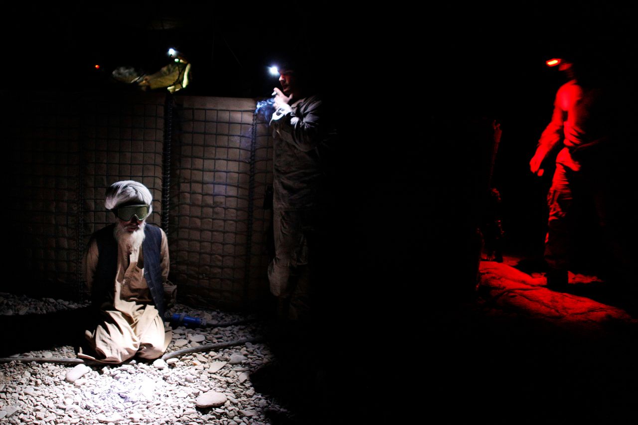 An Afghan man is detained by US Marines after they battled Taliban insurgents in Afghanistan's Helmand province in November 2010.