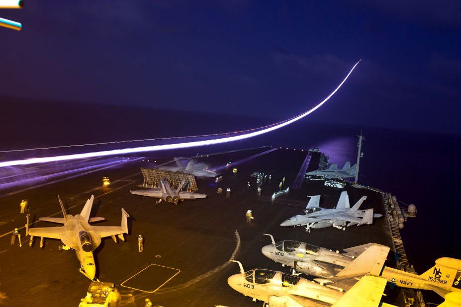 In this long-exposure photo, a jet takes off from the flight deck of the USS John C. Stennis, an aircraft carrier that was in the northern Arabian Sea in January 2012.