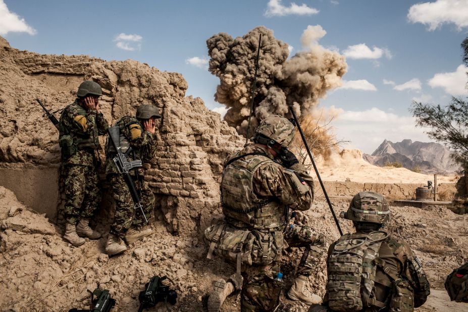 Afghan soldiers, left, and American troops blow up a Taliban firing position in the Afghan village of Layadira in February 2013.