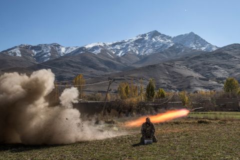 Afghan Army Sgt. Sayed Wazir screams a prayer while firing a rocket in Afghanistan's Wardak province in November 2013.