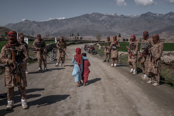 Two children pass members of a Taliban Red Unit in Afghanistan's Laghman province in March 2020. A month earlier, the United States and the Taliban <a href="index.php?page=&url=https%3A%2F%2Fwww.cnn.com%2F2020%2F02%2F29%2Fpolitics%2Fus-taliban-deal-signing%2Findex.html" target="_blank">signed a historic agreement.</a>