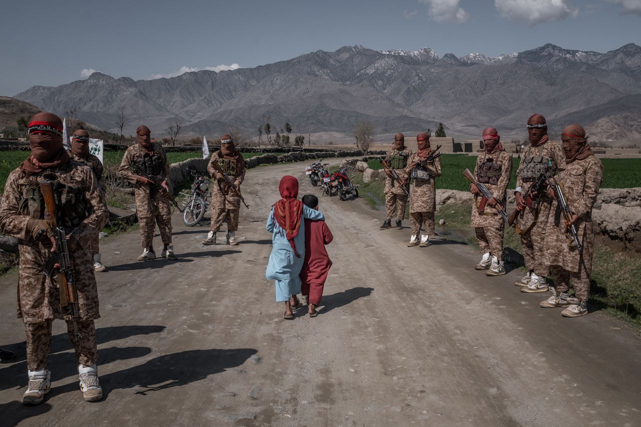 Two children pass members of a Taliban Red Unit in Afghanistan's Laghman province in March 2020. A month earlier, the United States and the Taliban <a href="https://www.cnn.com/2020/02/29/politics/us-taliban-deal-signing/index.html" target="_blank">signed a historic agreement.</a>