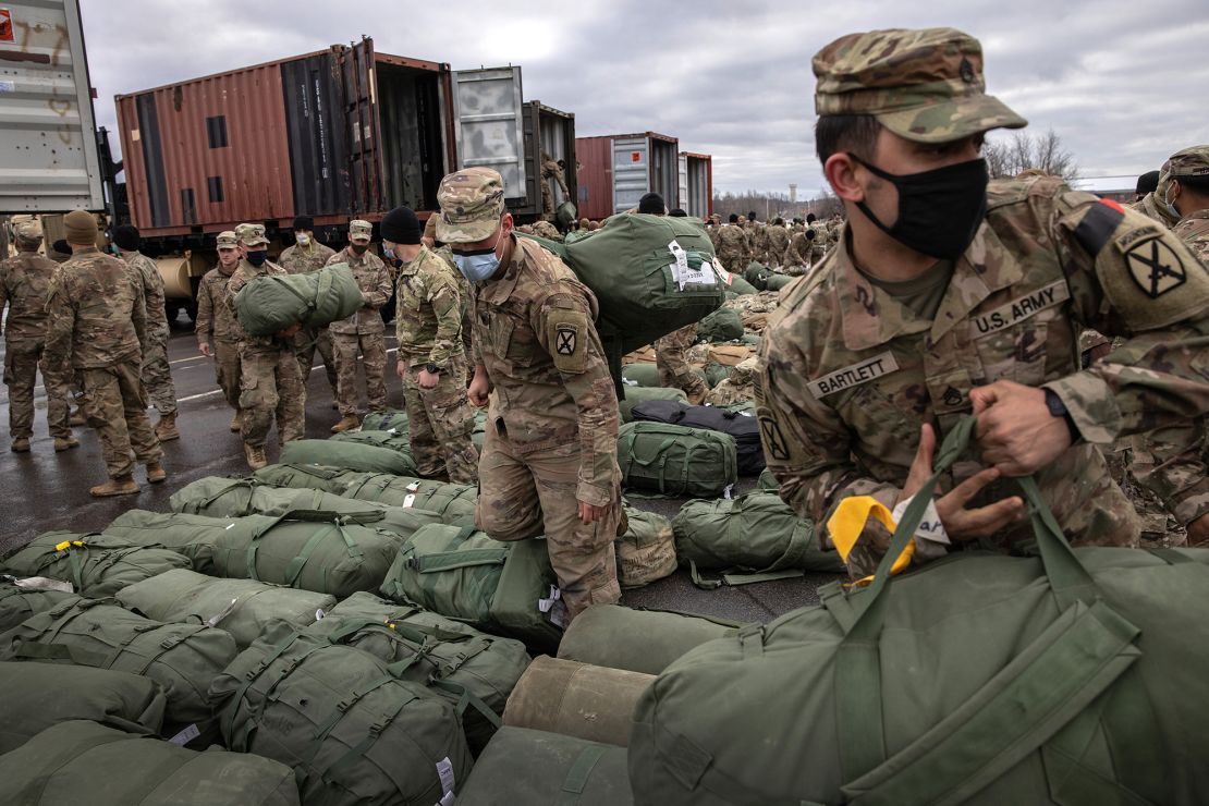 US Army soldiers retrieve their duffel bags after they returned home from a 9-month deployment to Afghanistan on December 10, 2020 at Fort Drum, New York.