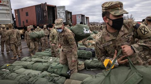 US Army soldiers retrieve their duffel bags after they returned home from a 9-month deployment to Afghanistan on December 10, 2020 at Fort Drum, New York.