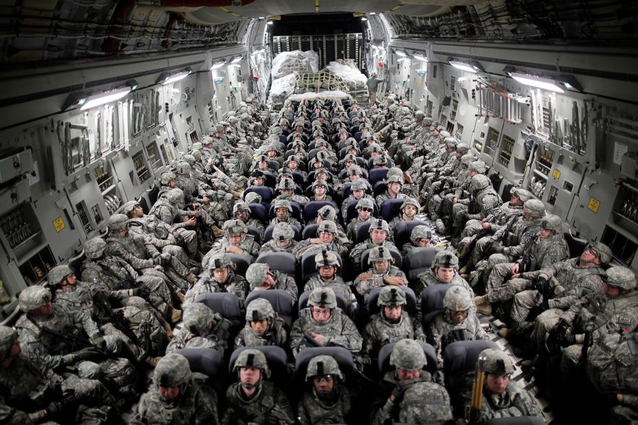 US troops, aboard a C-17 transport plane, head to Afghanistan in April 2010.